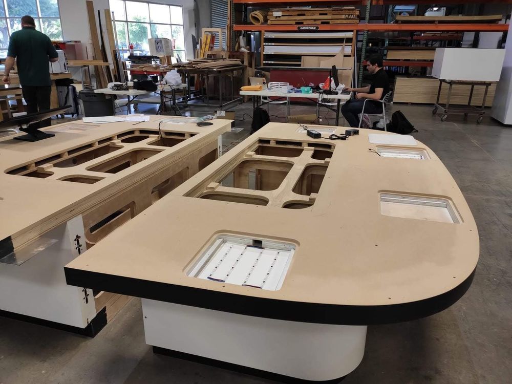 The modular two-part MDF base of the model under fabrication, showing cut-outs and the hollow serviceable core