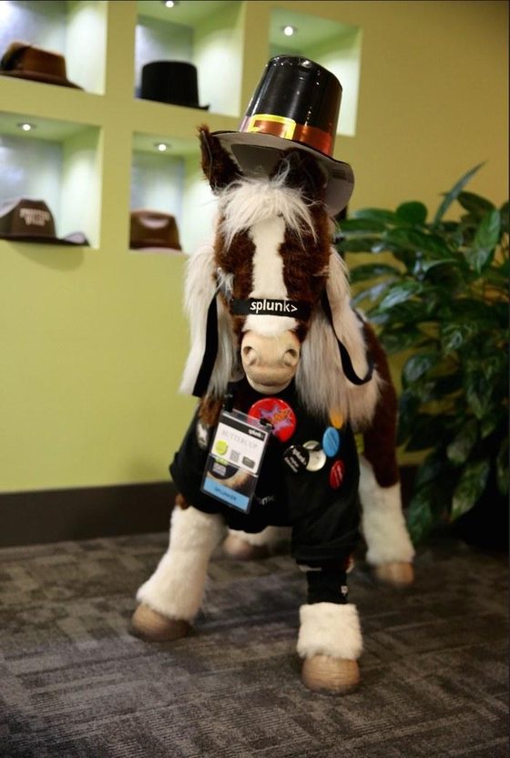 Plush Buttercup mascot in a top hat and Splunk vest